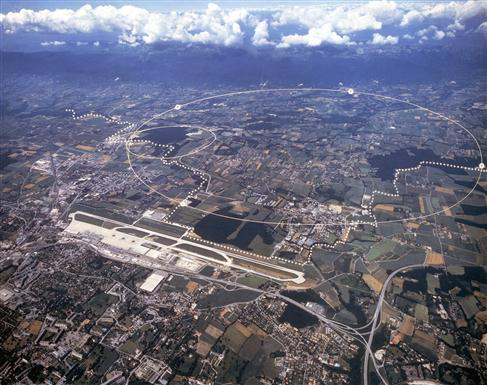 Aerial view of the CERN site just outside Geneva. The underground particle accelerators (with circumferences of 27 km and 7 km) allow scientists to look at tiny scales. Image © <a href='http://public.web.cern.ch/Public/Welcome.html'>CERN</a>.