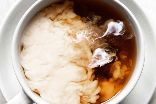 Milk being mixed into tea