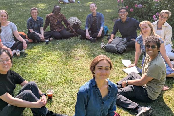 Participants at the "Use of Modelling" workshop - day 2 - sitting on the grass in the sunshine
