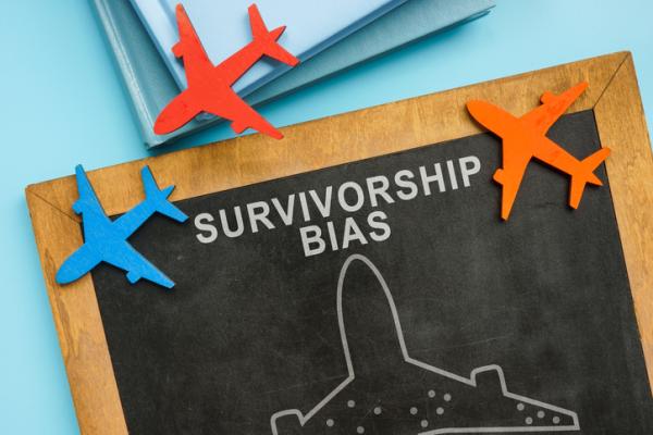 Chalkboard saying Survivorship bias, surrounded by little planes