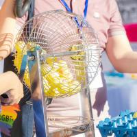 Yellow Bingo Balls being rolled in a cage