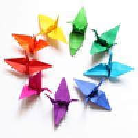 Origami cranes in a circle in rainbow colours
